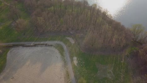 Fly-over-the-pathway-going-to-the-lake-drone-footage
