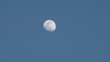 The-moon-glowing-against-a-light-blue-sky
