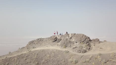 Aerial-Drone-Shot-of-Group-of-People-on-Mountain-in-Death-Valley