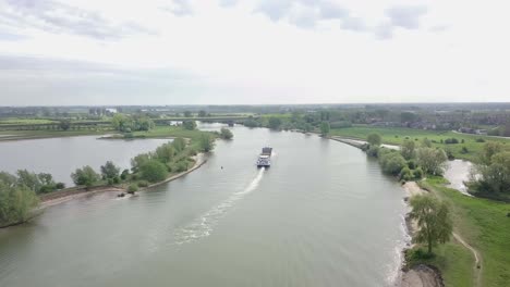 Aerial-footage-of-the-cargo-ship-on-the-river-going-away-to-the-destination