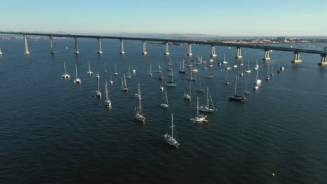 Beautiful-skyline-of-downtown-San-Diego-showing-all-the-building-flying-over-the-Harbor-viewing-some-boats