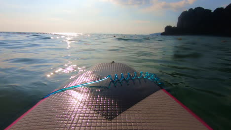 surfboard-POV-sun-against-the-blue-sea-with-cliffs-in-background-in-Railay-Thailand-Asia-in-cinematic-60fps