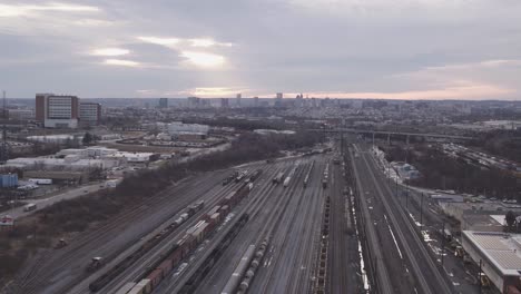 Overview-clip-of-sunrise-over-the-horizon-of-a-train-yard