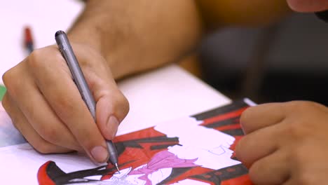 Close-up-of-an-artist-drawing-Alucard-from-Hellsing-anime-series-at-the-Cyprus-Comic-Con-in-Nicosia,-Cyprus