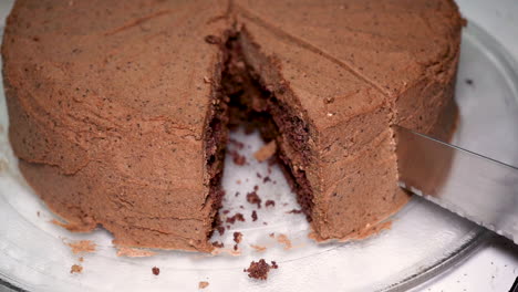 Slow-motion-cutting-a-piece-of-delicious-low-carb-chocolate-ketogenic-cake-with-a-serrated-knife