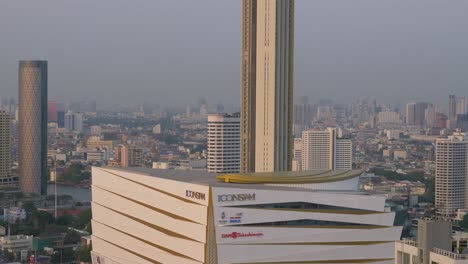 Tilt-up-view-across-Bangkok-downtown-city-skyline-new-shopping-centre-Icon-siam-up-to-top-of-tower
