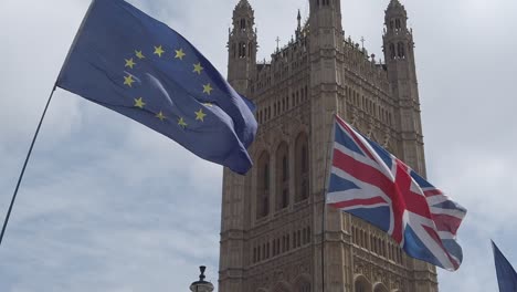 The-flags-of-the-European-Union-and-the-United-Kingdom-sway-in-the-wind-outside-the-Houses-of-Parliament