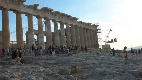 Tourists-enjoying-the-Parthenon-Temple-at-Acropolis-hill,-Athens,-Greece