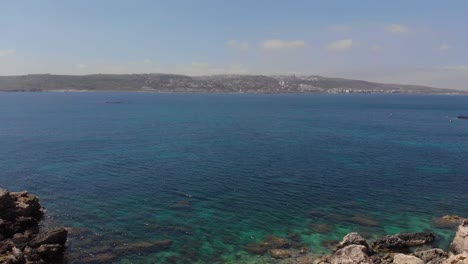 AERIAL:-Flying-through-rocks-and-cliffs-at-Mediterranean-coastline-in-summer