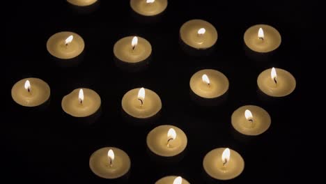Candles-Timelapse---Small-Candles-Burning-On-Black-Background