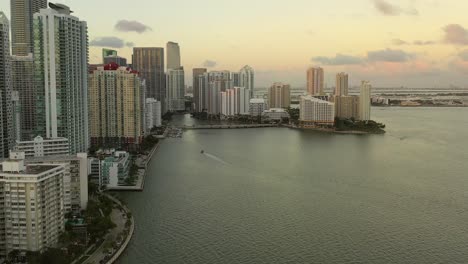 Cinematic-Approach-Aerial-Shot-of-Brickell-Key-In-Miami-Florida-at-Sunset-During-Golden-Hour