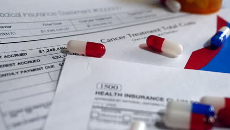 Prescription-drug-bottles-and-pills-on-a-medical-health-care-insurance-form-SLIDE-RIGHT