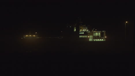 Wide-shot-of-a-cargo-ship-in-Matosinhos-at-night,-parked-by-the-docks