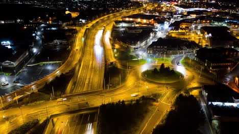 An-aerial-view-of-a-night-time-time-lapse,-timelapse-of-the-A50,-A500-dual-carriage-way,-motorway,-high-way-in-the-heart-of-the-midlands-area-of-Stoke-on-Trent,-Staffordshire,-English-A-road
