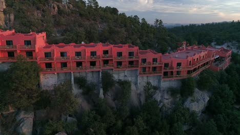 Aerial-drone-shot-of-a-hotel-in-the-Urique-Canyon-at-sunrise-in-Divisadero,-Copper-Canyon-Region,-Chihuahua