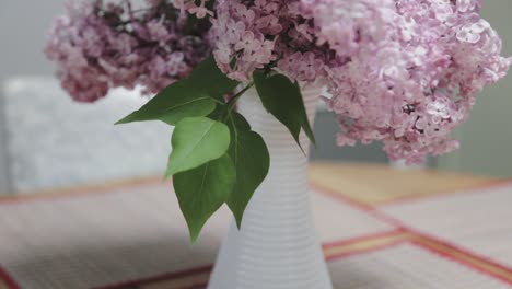 Close-up-panning-shot-of-lilacs-on-a-kitchen-table