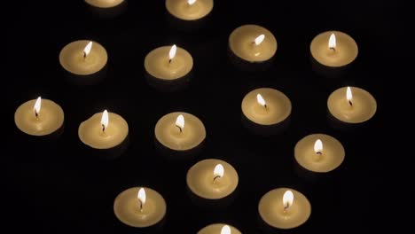 Candles---Small-Candles-Burning-On-Black-Background