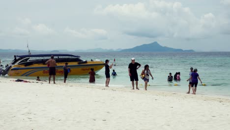 Travelers-travel-to-the-island-by-boat-to-see-the-beauty-and-sunbathing-at-the-beach-front,-with-a-long-beach,-suitable-for-swimming-at-Krabi-in-Thailand