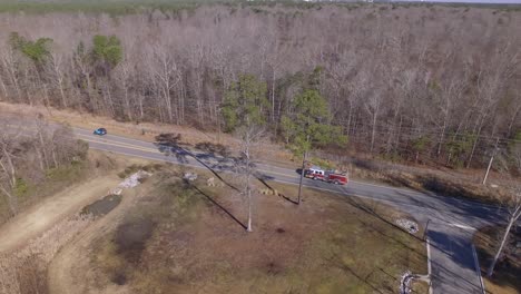 Aerial-of-a-firetruck-driving-on-a-road-on-its-way-to-an-emergency
