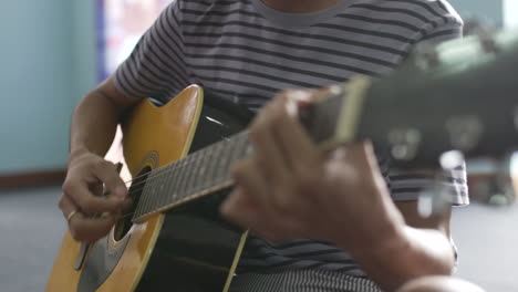 Close-up-of-man-playing-guitar