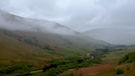 Cinematic-drone-shot-of-scottish-highlands-landcsape-with-winding-road