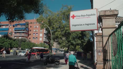 Spanish-Red-Cross-Urgent-Care-Sign-on-Street-of-Seville,-Spain
