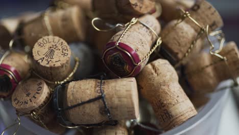 Closeup-of-a-bunch-of-Bollinger-champagne-corks-laying-on-a-bucket
