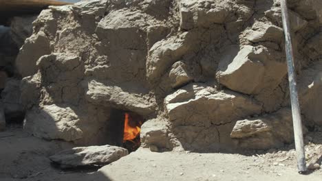 Fire-through-flue-of-tradtional-self-built-Tandoor-oven-in-refugee-camp
