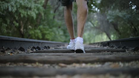 Slow-Motion-Shot-of-someone-walking-on-abandoned-Train-Tracks