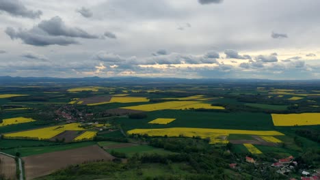 Hyperlapse-aerial-view-of-clouds-moving-over-fields-in-beautiful-countryside