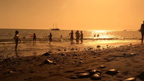 Amazing-destination-silhouetted-people-family-volvanic-rock-beach-golden-hour-travel-holidays-vacation-leisure-time-tranquility-serenity-relaxed-seaside-paradise-sunset-party-summertime-activity