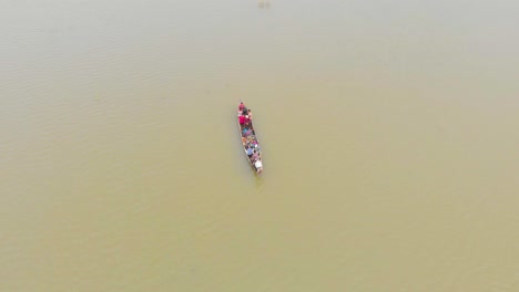 4k-Aerial-Top-Down-shot-of-People-in-a-Row-Boat-getting-evacuated-to-land-area-in-Majuli-river-island-submerged-in-the-Brahmaputra-Monsoon-floods