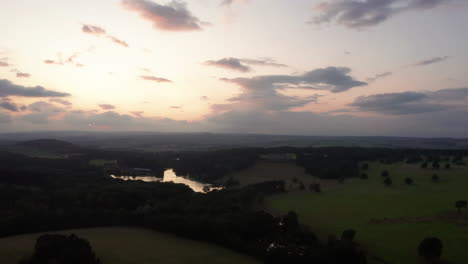 Aerial-Flyover-of-Country-Estate-and-Lake-during-Sunset