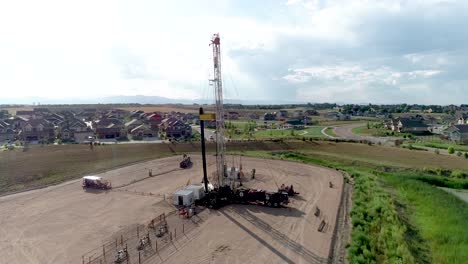 A-drone-shot-of-an-oil-well-extraordinarily-close-to-a-wealthy-fancy-neighborhood