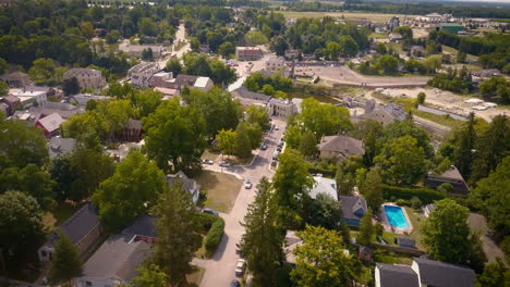Aerial-flyover-of-the-picturesque,-small-town-of-Elora,-Ontario,-Canada