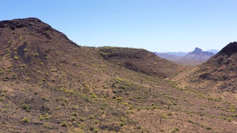 Aerial-slow-pan-across-the-mountainous-desert-landscape,-Salt-River-Indian-Reservation,-Scottsdale,-Arizona