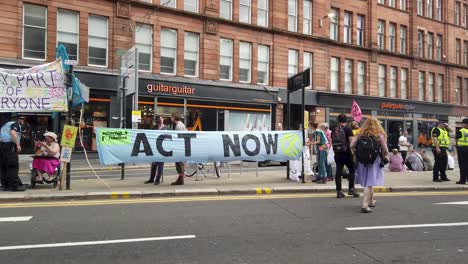 Extinction-Rebellion-protesters-and-police-surrounded-by-banners-on-a-blocked-main-road