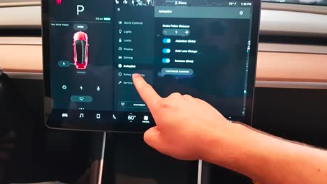 Passenger-using-Tesla-Model-3-touchscreen-in-Tesla-store-in-Stanford-Shopping-Center,-California,-USA