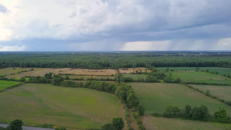 Aerial-flying-over-a-scenic-countryside-with-rain-falling-in-the-distance