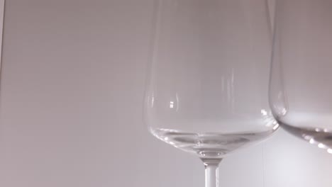 Static-shot,-hand-grabbing-an-Iittala-wine-glass,-made-in-Finland