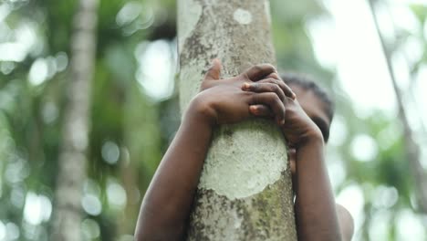 Motion-shot-Indian-boy-climbs-a-tree,-rural-environment,-Karnataka-India