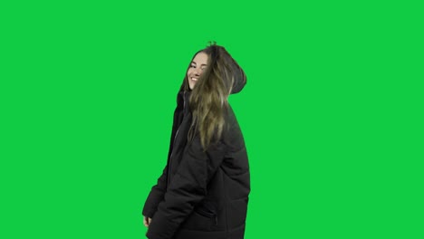 Happy-girl-playing-around-with-the-jacket-in-front-of-the-green-screen
