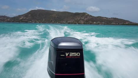 The-wake-and-engine-of-a-speed-boat-on-the-Crystal-clear-waters-of-Carriacou,-Grenada