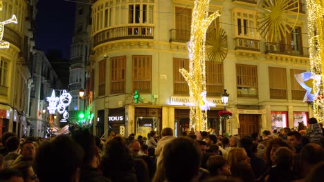 People-enjoying-Christmas-light-show-on-Calle-Larios,-Malaga