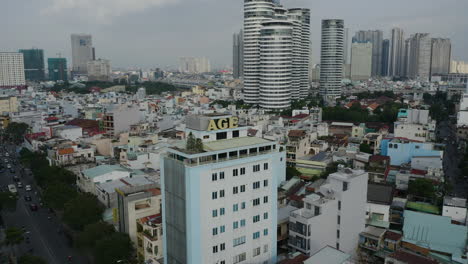 Afternoon-drone-orbit-of-an-old-office-building-with-the-name-"AGE'-on-top-in-Binh-Thanh-district-of-Ho-Chi-Minh-City,-Vietnam