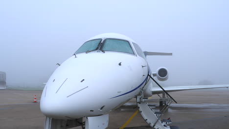 Aircraft-shot-from-the-front-on-a-cold,-misty-winter-day-with-frozen-fuselage-and-windows