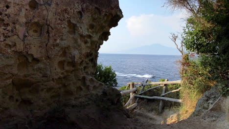 View-Through-Cove-Onto-Gulf-Of-Naples-With-Boat-Going-Past