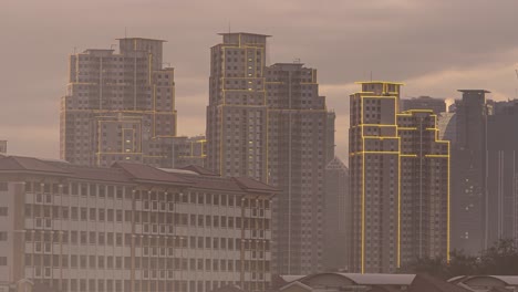 Smoky-cloudy-sunset-timelapse-view-of-skylines-with-yellow-lights-around