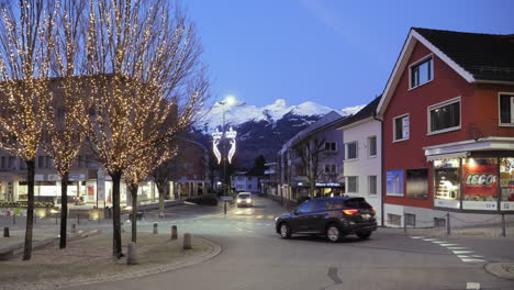 Vaduz-Liechtenstein-Christmas,-gorgeous-decorated-trees-and-snowy-mountains-in-the-background