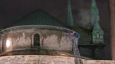 Slow-pan-shot-of-historic-religious-building-with-smoke-from-fire
